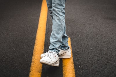 Dressed in blue denim jeans and white Nike sneakers
